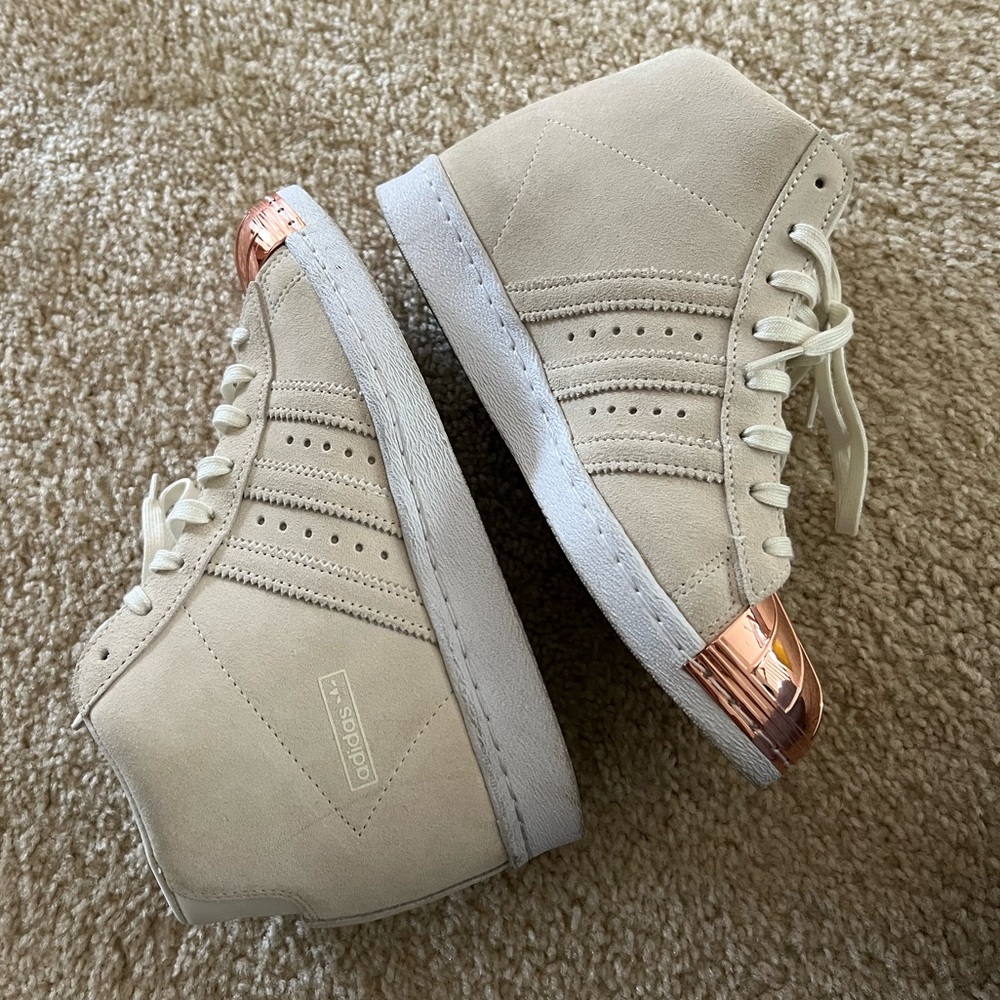 Adidas Superstar high tops with built in wedge.